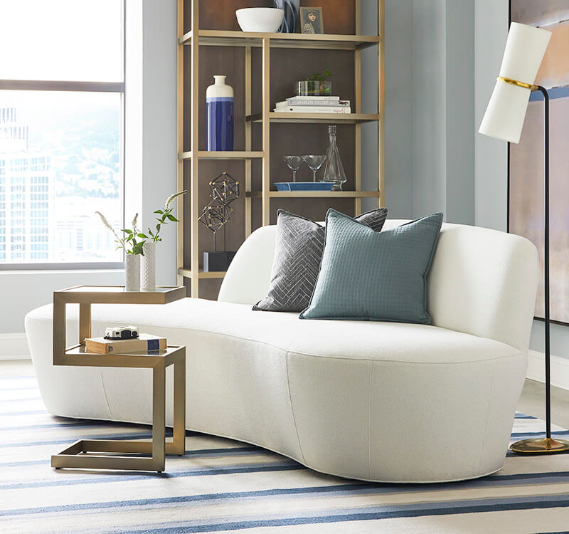 A gently curved white sofa in a contemporary setting